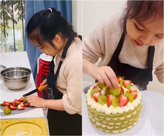 Bé Gà khéo léo xếp dâu tây và nho xanh lên mặt bánh để trang trí.